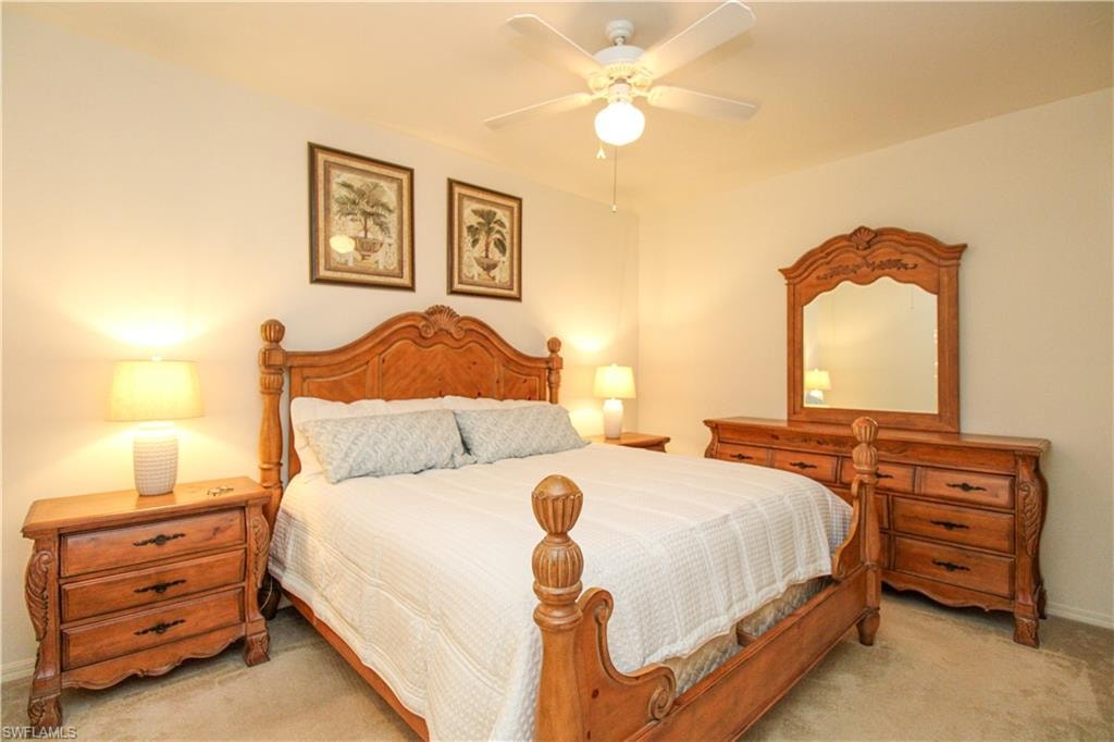Carpeted bedroom with ceiling fan