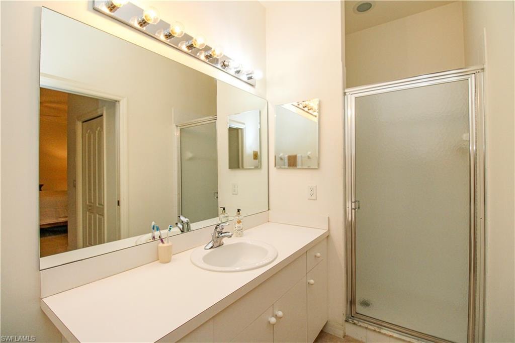 Bathroom with an enclosed shower and vanity