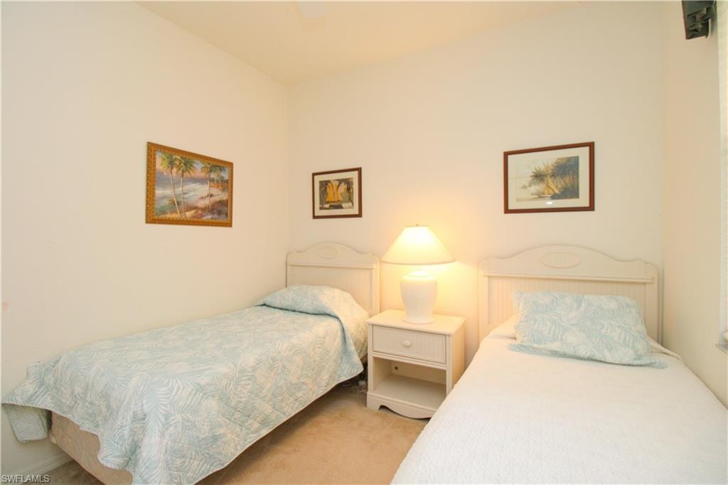 Bedroom with light colored carpet