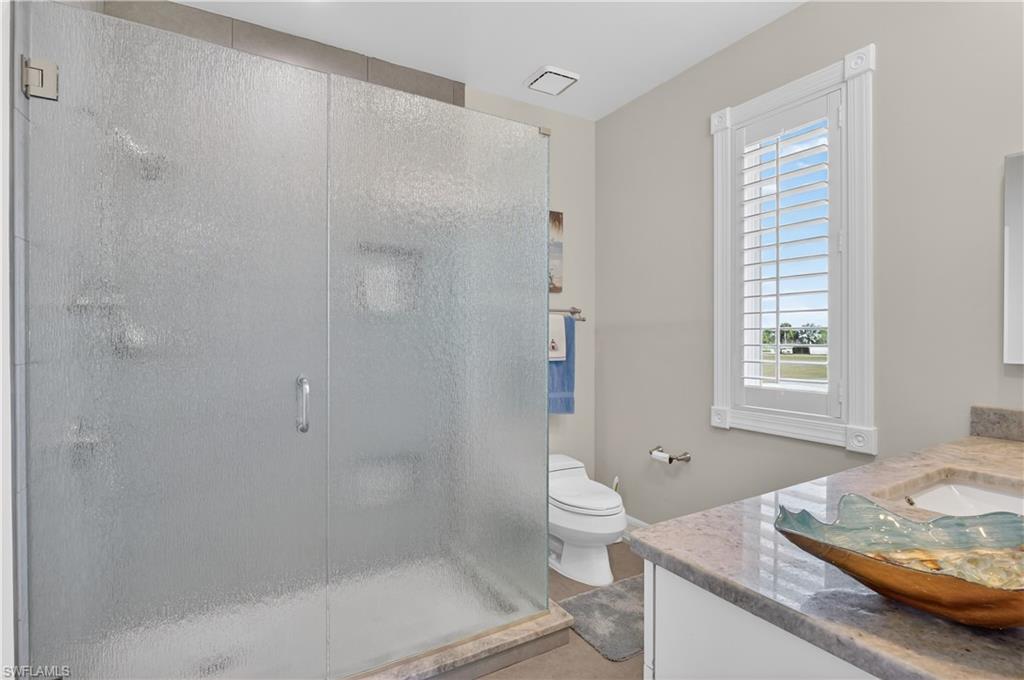 Full bath with vanity and a shower stall