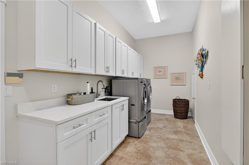 Laundry area with cabinet space and washing machine and dryer
