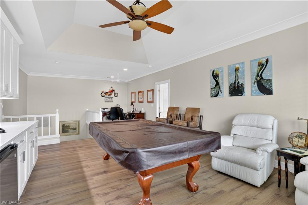Playroom featuring billiards, recessed lighting, ornamental molding, light wood-style flooring, and a ceiling fan