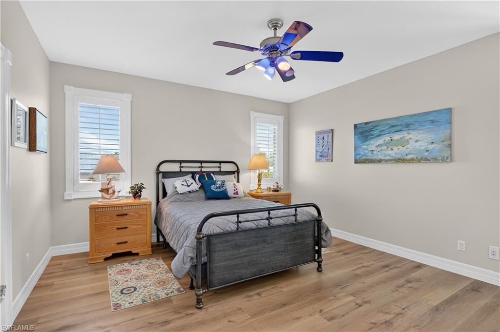 Bedroom with light wood-style flooring and a ceiling fan