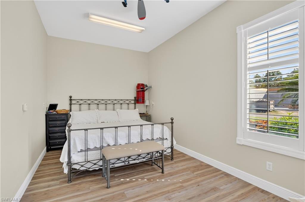 Hangar Bedroom or oofice with light wood-style flooring and a ceiling fan