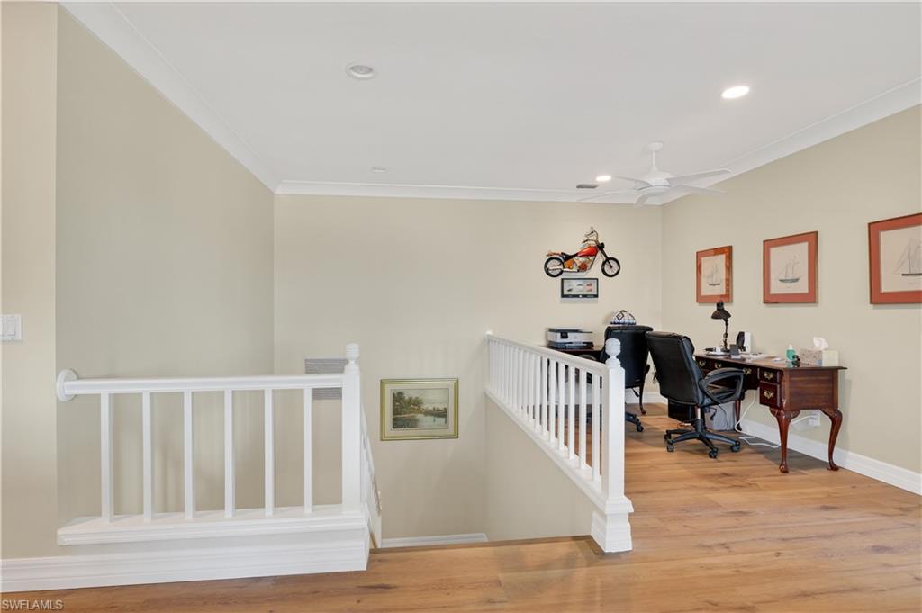 Home office with light wood finished floors, ornamental molding, recessed lighting, and ceiling fan