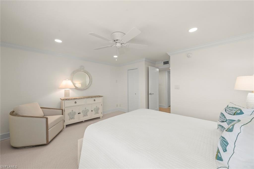 Bright bedroom featuring recessed lighting, a ceiling fan, crown molding, and carpet flooring