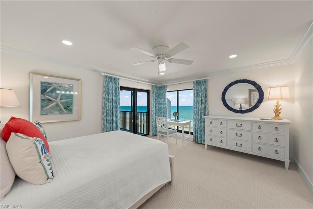 Bedroom featuring a private balcony, ocean backdrop, ceiling fan, recessed lighting, and crown molding