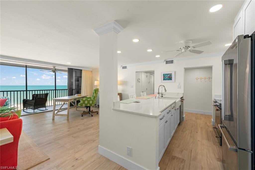 Open concept living space featuring wood-finish flooring and direct access to a screened balcony