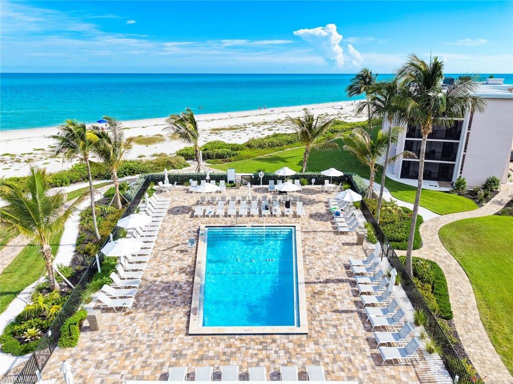Outdoor swimming pool surrounded by a paver patio and lounge chairs