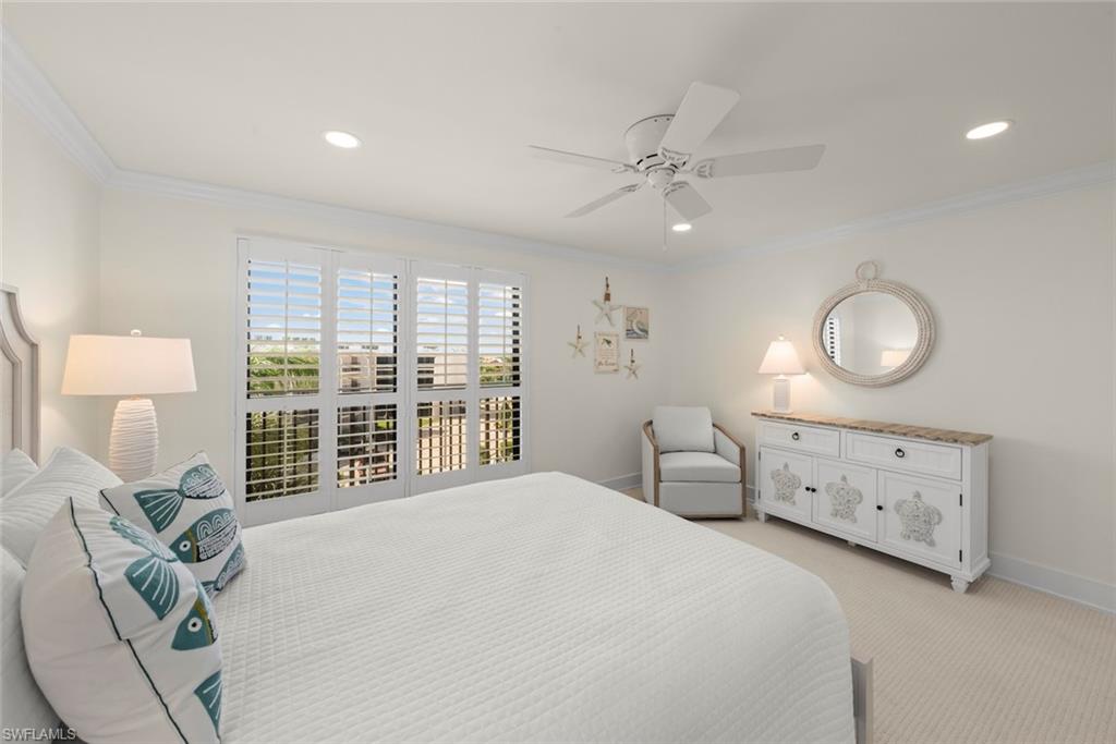 Wall-to-wall carpeting and white crown molding complement the bright interior
