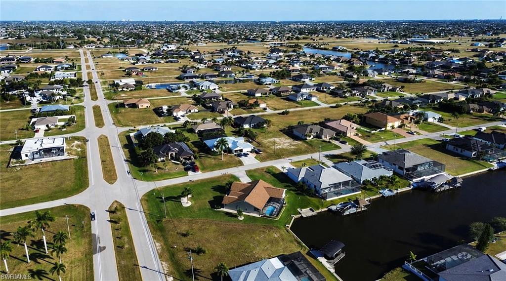 Aerial perspective showcasing a residential development with established homes and vacant lots