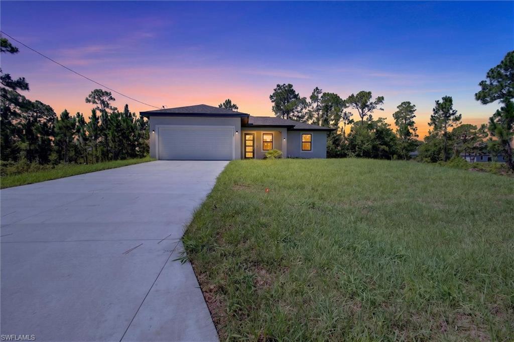 Contemporary single-story residence with a dark roof and light gray exterior