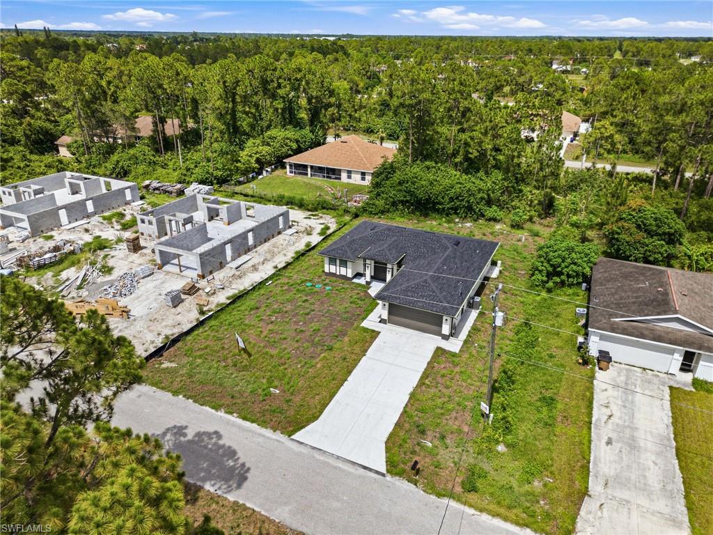 Modern single-story residence featuring a dark shingle roof, a two-car garage, and a concrete driveway