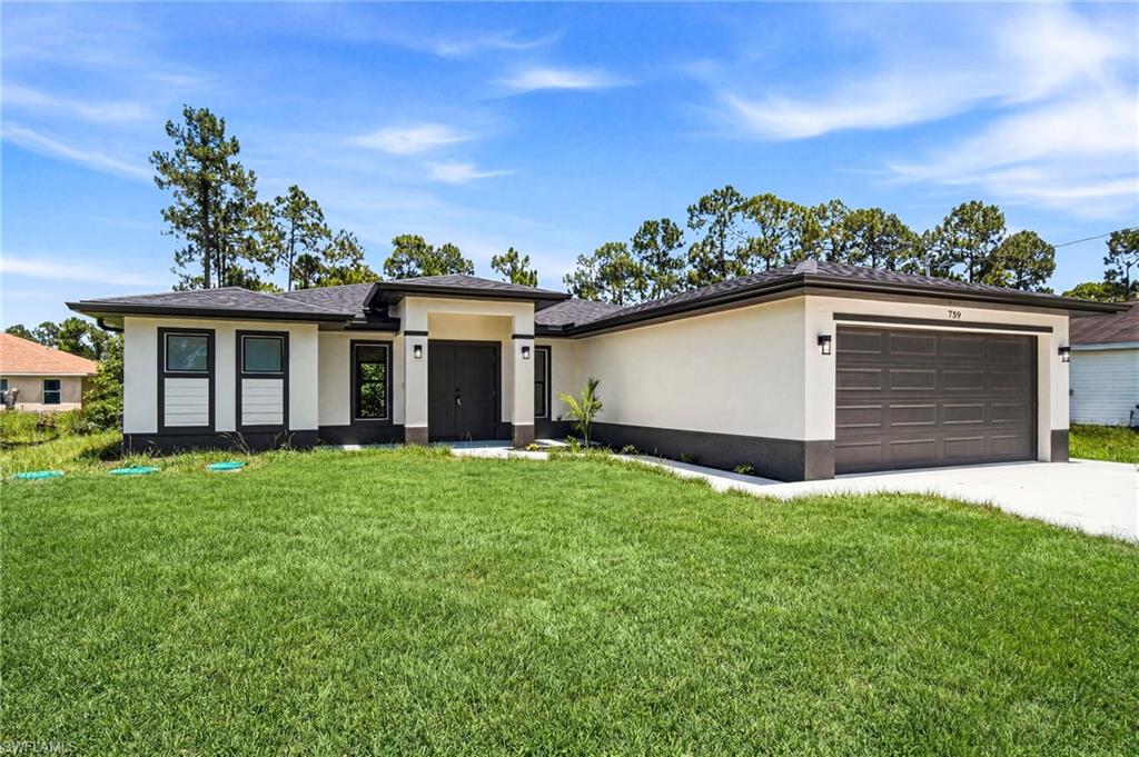 Contemporary one-story residence featuring a two-tone stucco exterior, a dark sectional garage door, a concrete driveway, and a covered entryway