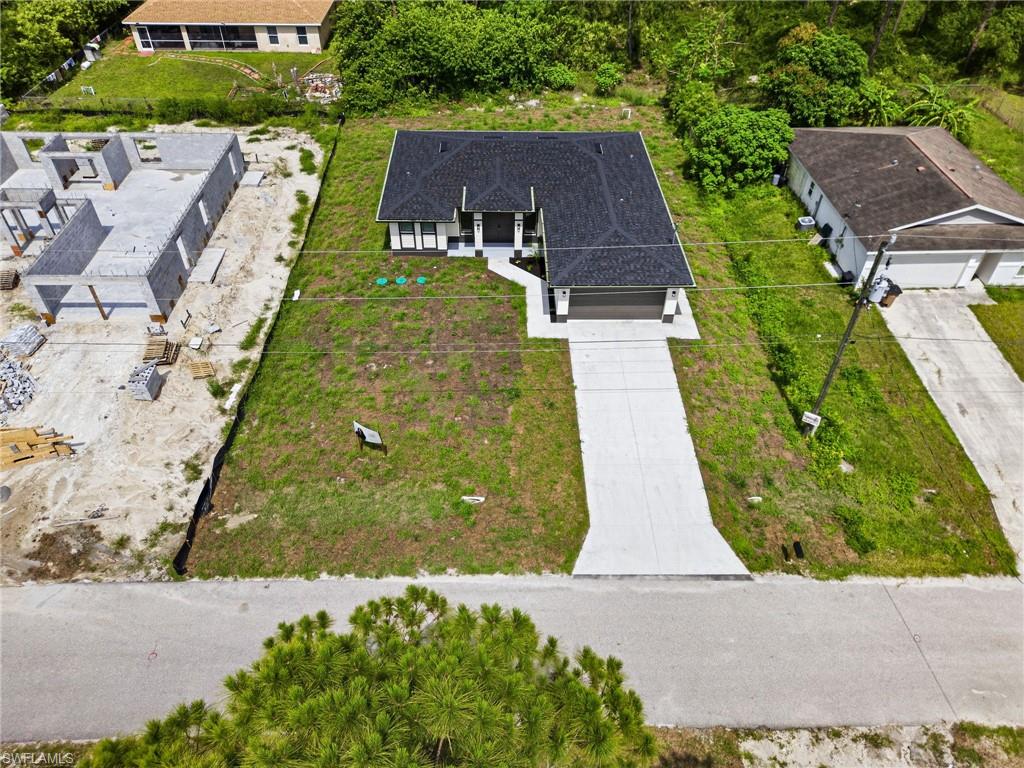 Single-story residence featuring a dark shingle roof and a light-toned exterior