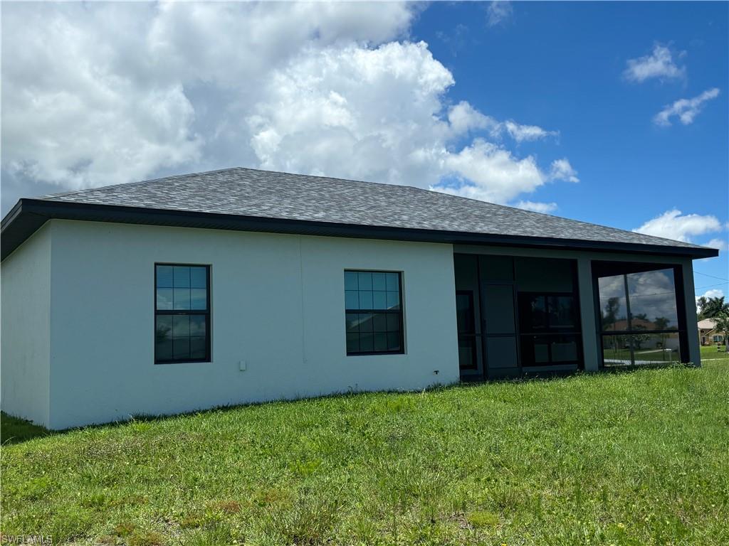 Rear view of property featuring a lawn