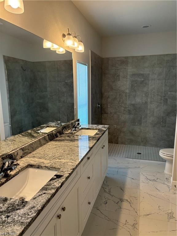 Bathroom with tile floors, dual sinks, oversized vanity, and toilet