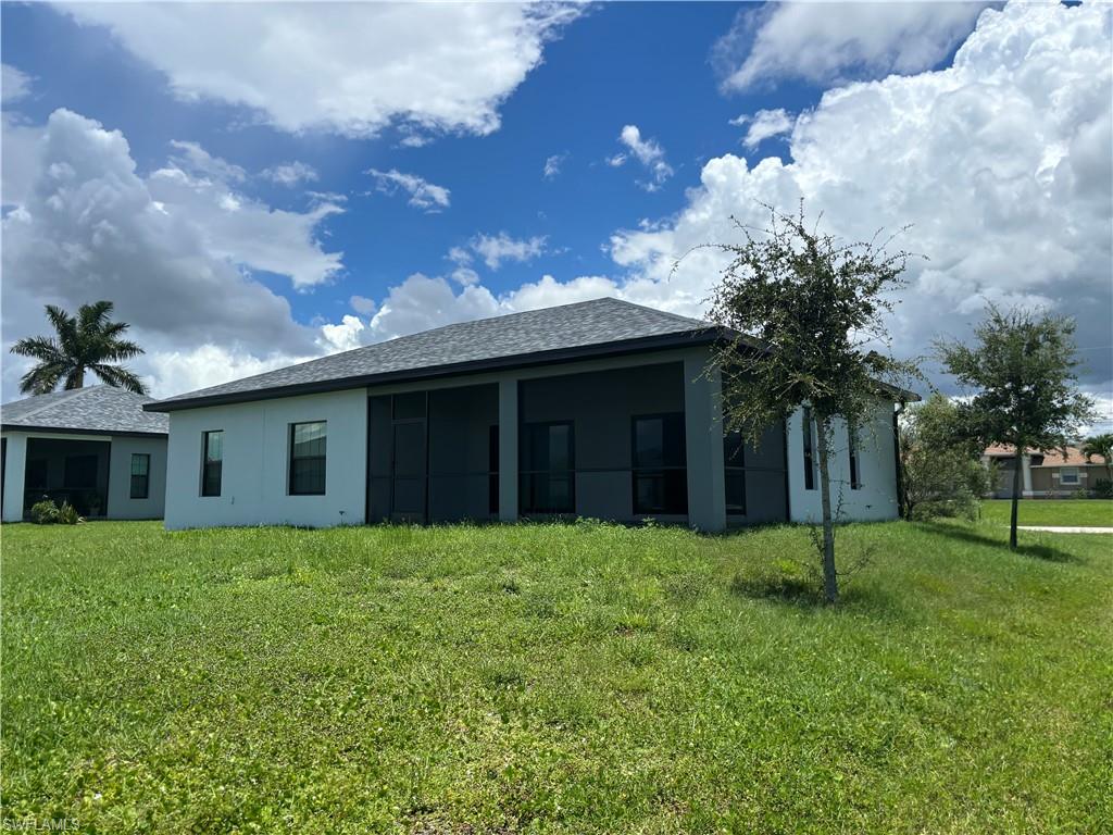 View of property exterior featuring a lawn