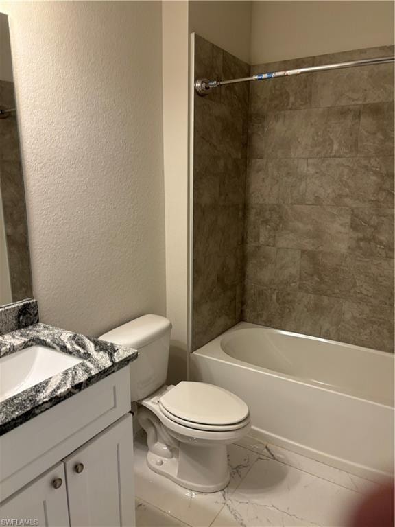 Full bathroom featuring tile flooring, tiled shower / bath, vanity, and toilet