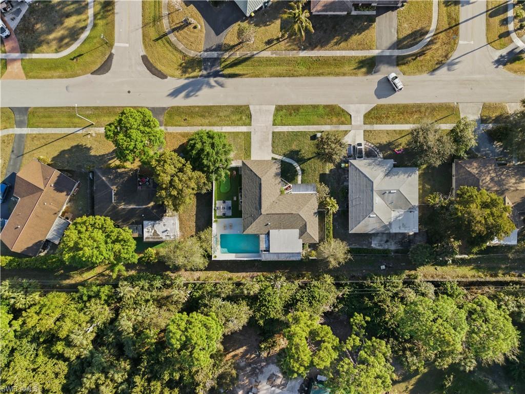 Aerial perspective showcasing the property with an in-ground swimming pool and a paved patio area
