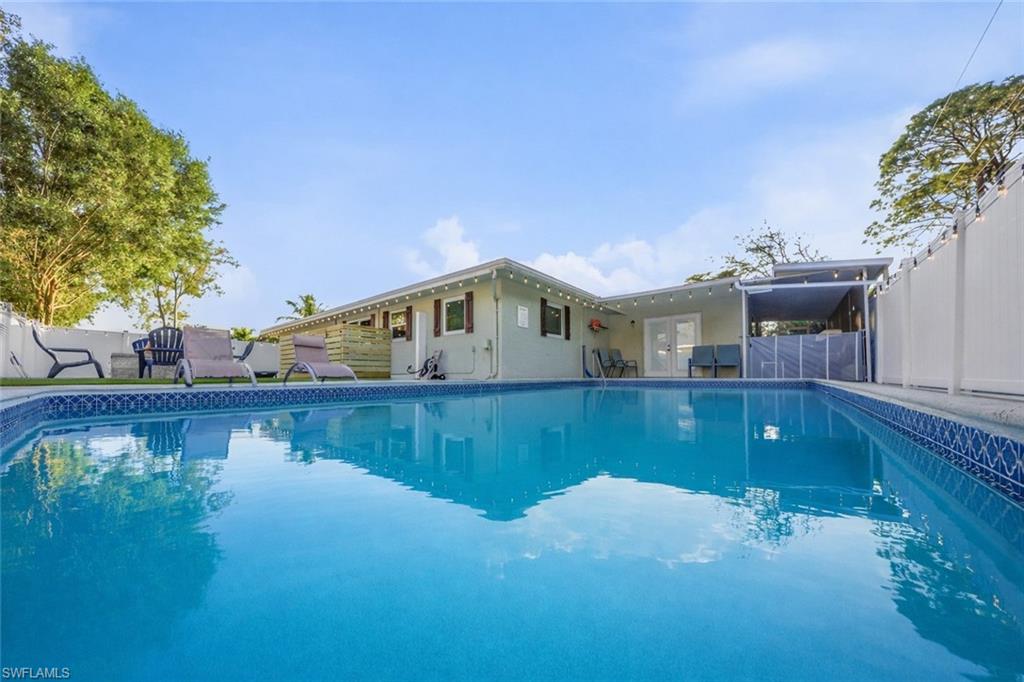 In-ground swimming pool with blue tile coping and patterned border