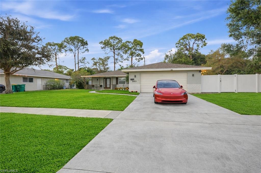 Ranch-style exterior with a paved driveway and an attached single-car garage