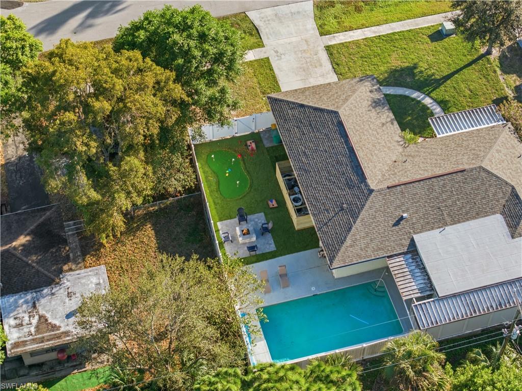 Exterior featuring a swimming pool, a putting green, and a concrete patio