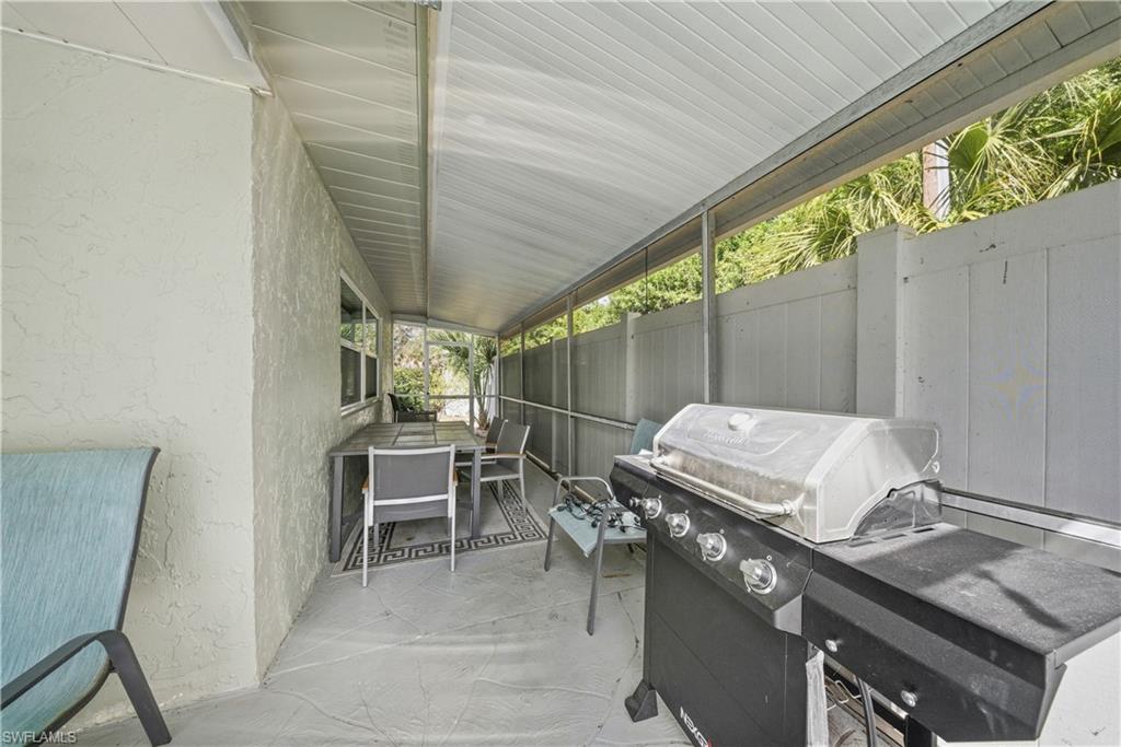 Covered patio featuring a solid roof structure and concrete flooring