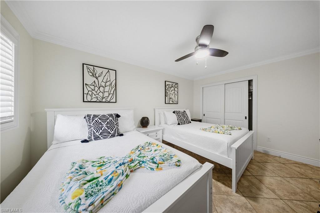 Neutral wall color, crown molding, and textured tile flooring