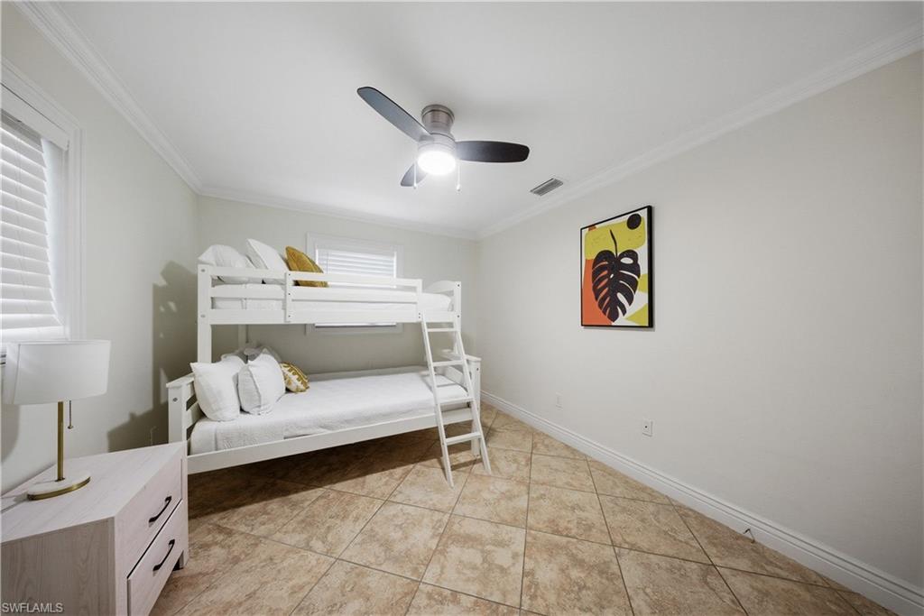 Room featuring large format tile flooring and white baseboards
