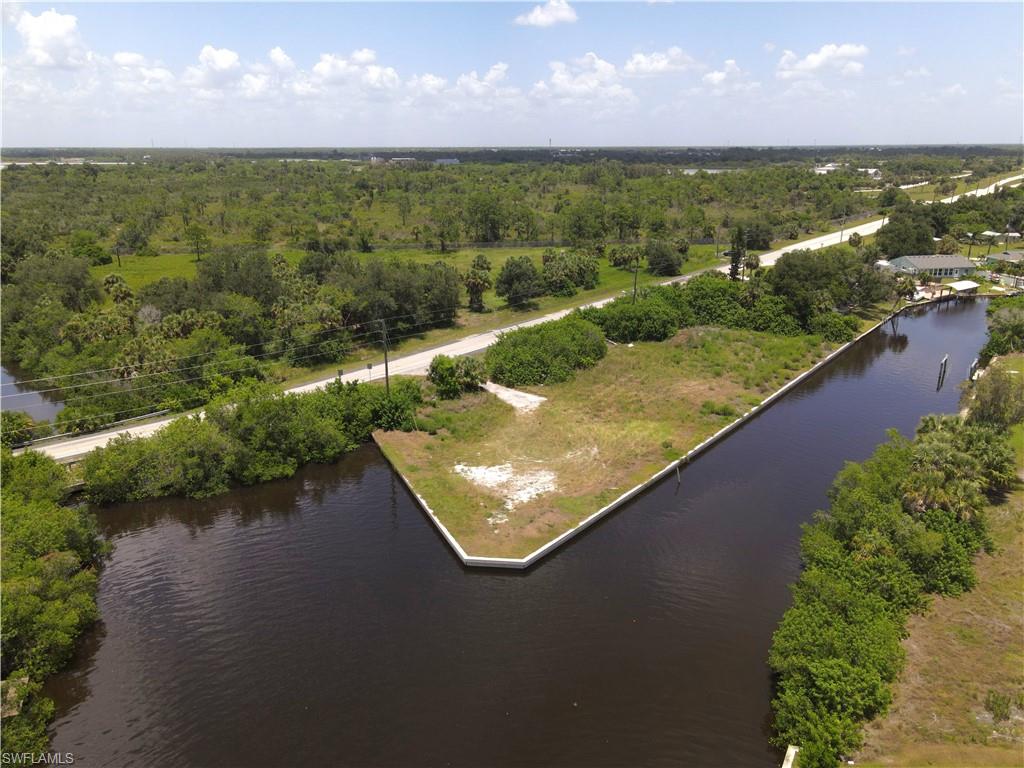 4 lots on the corner of an intersecting canal one block in from the Peace River with Direct Gulf Access! Cleared with seawall in place - build your dream home here!