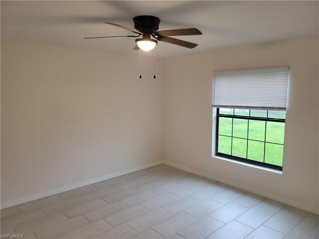 Unfurnished room featuring ceiling fan