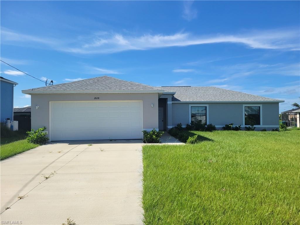 Ranch-style house with a garage and a front yard