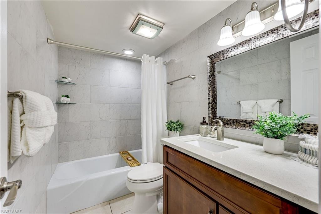 Guest bath updated with new tile, cabinet, countertop and sink.