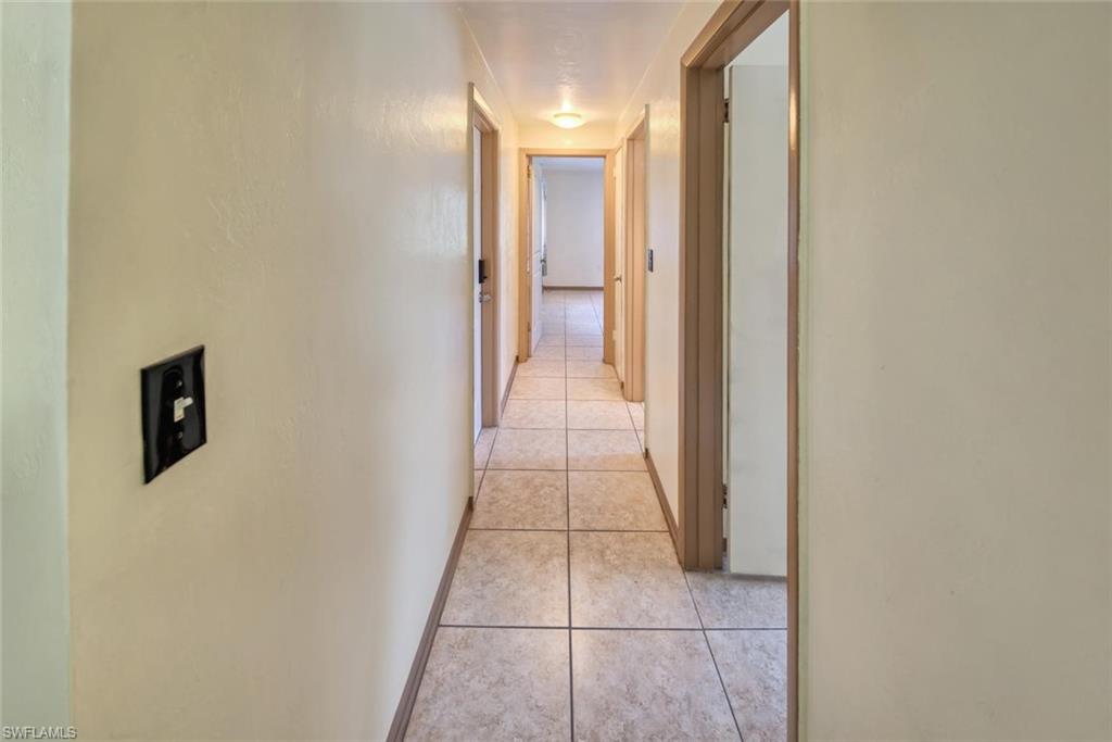 Corridor with light tile patterned floors