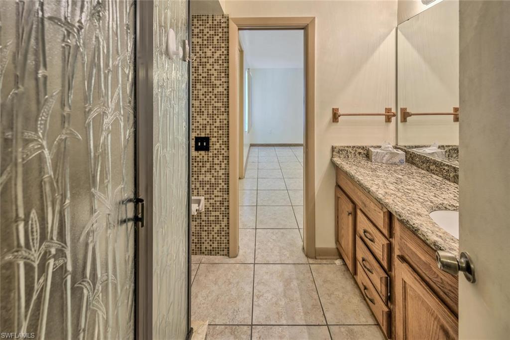Bathroom with tile patterned floors and vanity