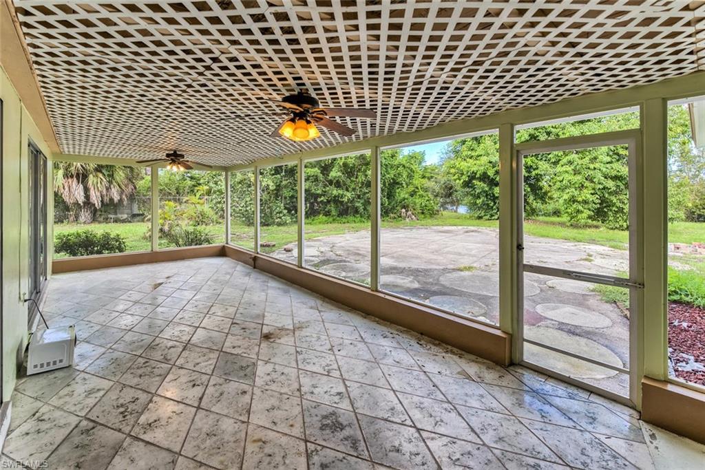 Unfurnished sunroom with ceiling fan