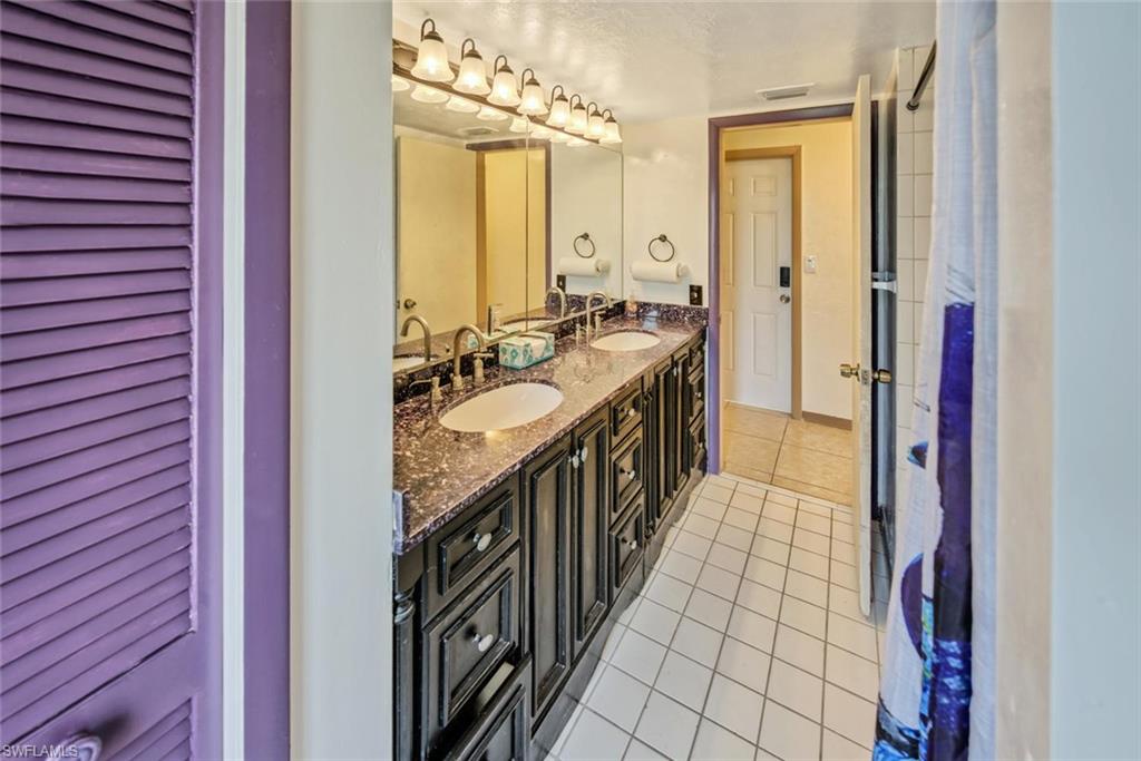 Bathroom with tile patterned flooring and vanity