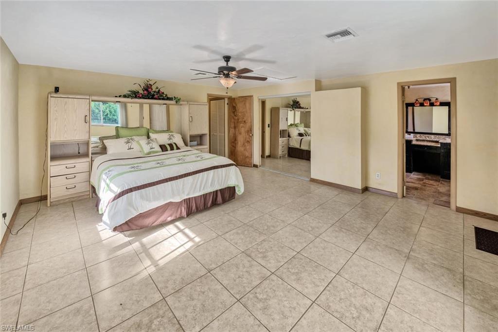 Bedroom with light tile patterned flooring and ceiling fan