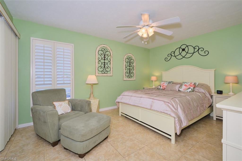Main bedroom.  Plantation shutters throughout home.  Main bedroom sliders open up to the lanai.  Again, tastefully decorated.