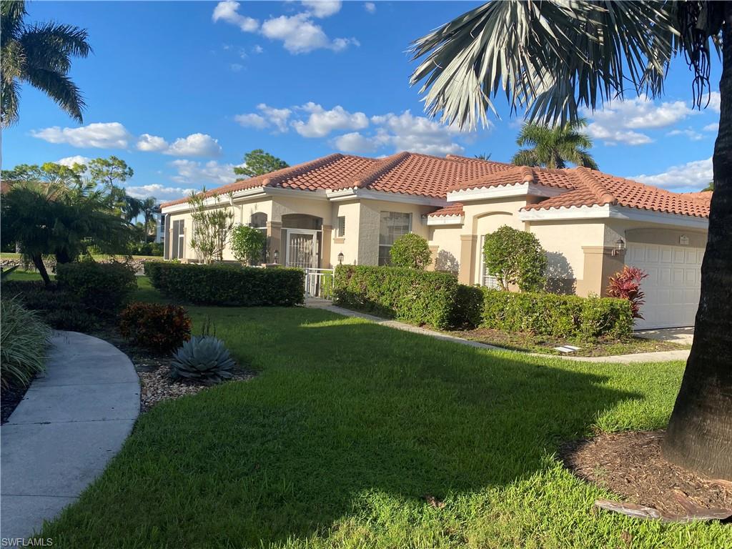 Mediterranean / spanish-style home featuring a garage, a tiled roof, stucco siding, and a front yard