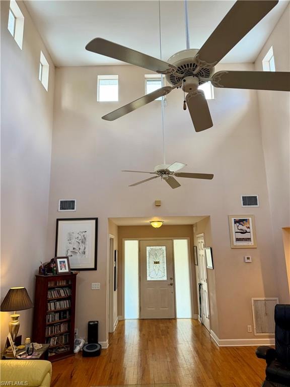 Soaring vaulted ceilings with multiple ceiling fans and high-set windows
