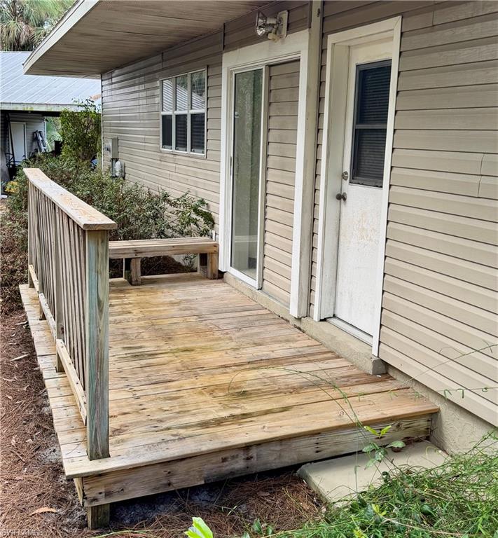 Private exterior deck with wood-finish railing and built-in bench