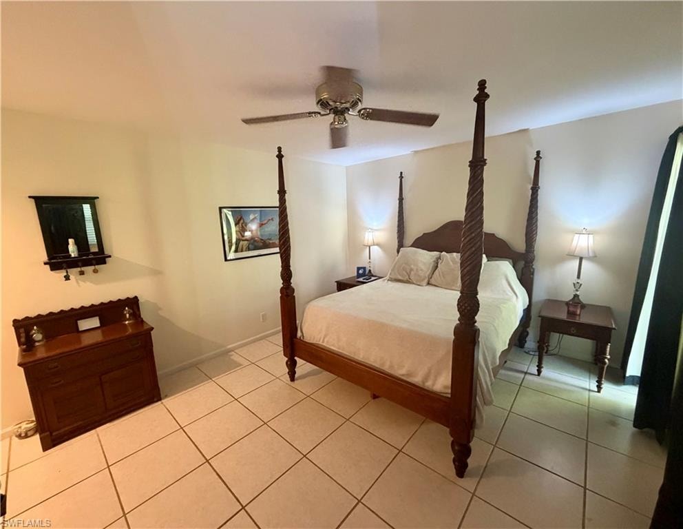 Spacious room featuring neutral wall tones, large format tile flooring, and a ceiling fan with integrated lighting