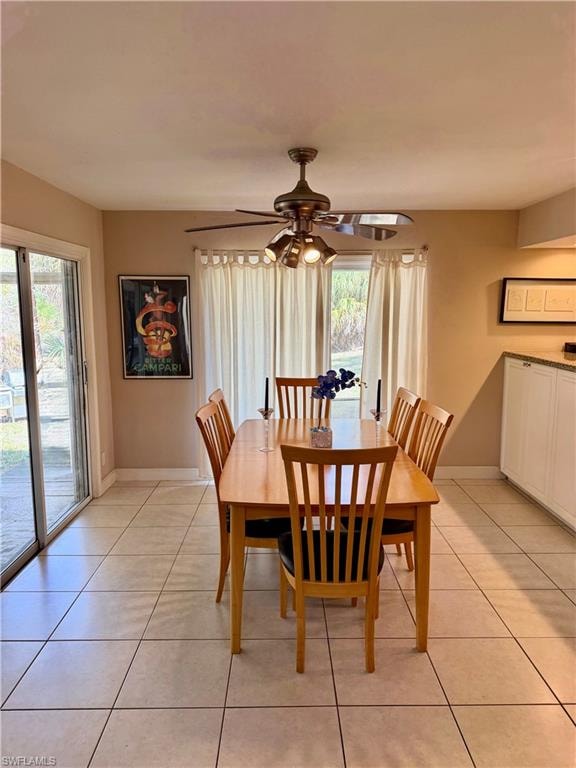 Bright dining area featuring sliding glass doors and tile flooring