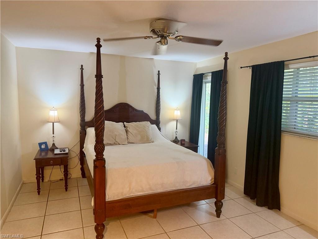 Spacious room featuring tile flooring, neutral wall tones, and a ceiling fan with integrated lighting