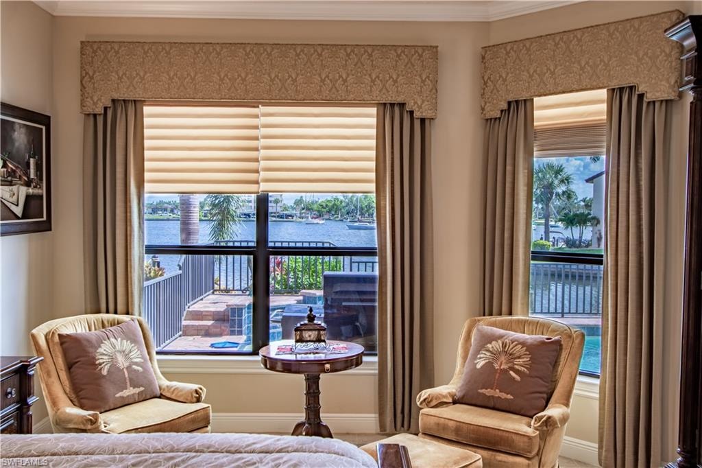 Bay window featuring water frontage, custom window treatments with valances, and light-filtering cellular shades