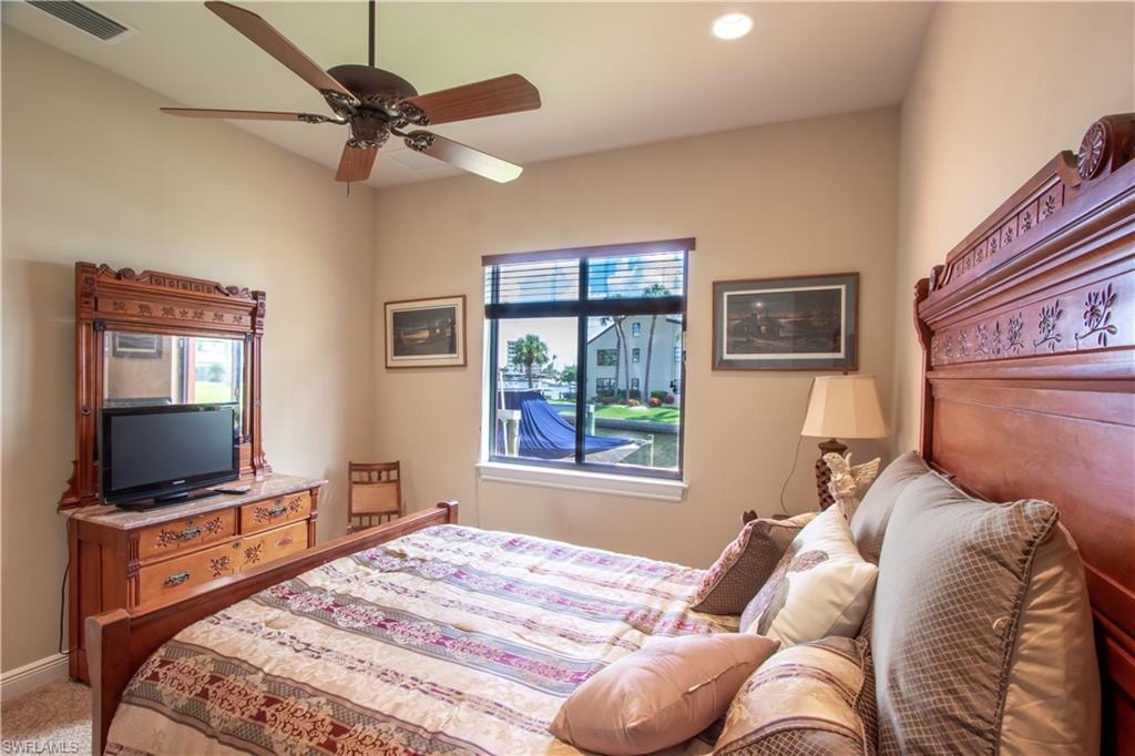Bedroom featuring a ceiling fan, recessed lighting, and a window with horizontal blinds