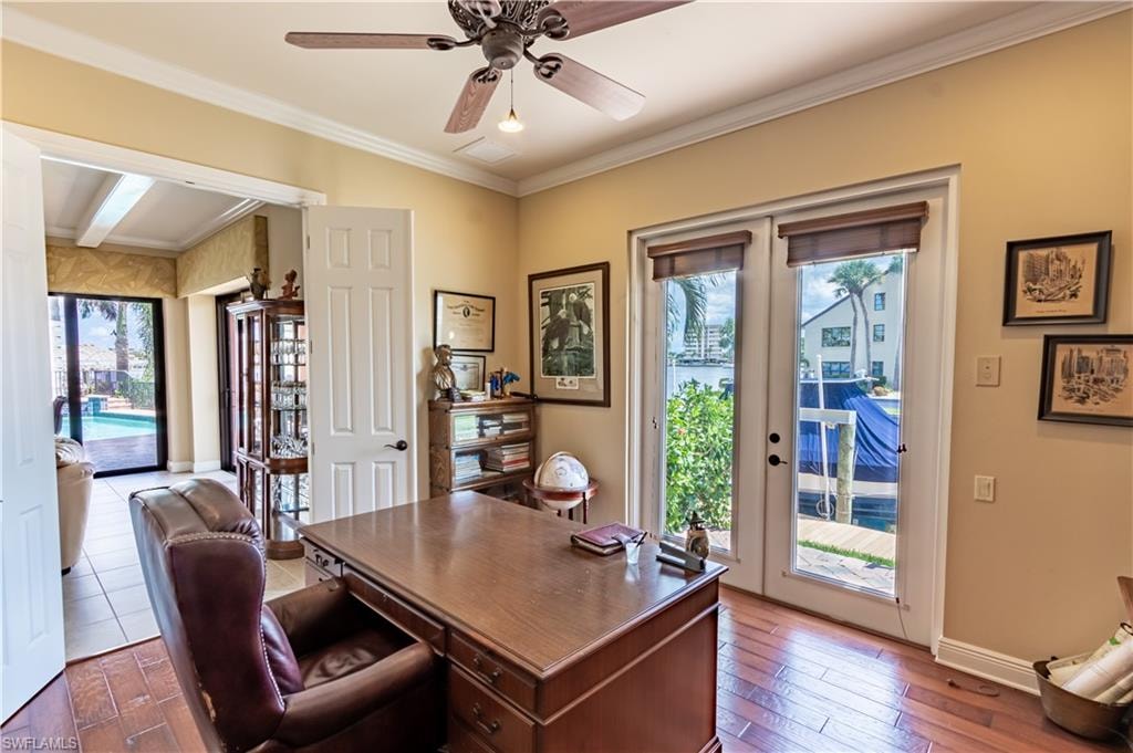 Wood-finish flooring throughout, featuring a ceiling fan with integrated lighting