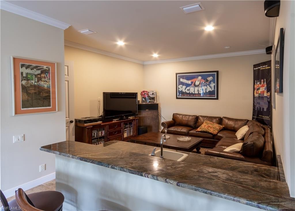 Upstairs versatile space. Wet bar. Sofas.